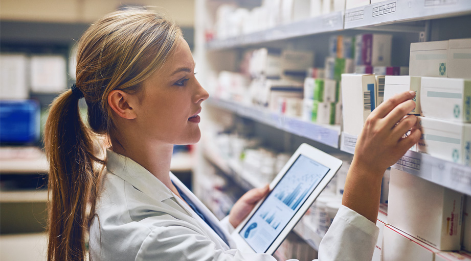 female pharmacist looking at medication
