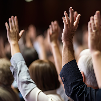 Group of people raising their hands