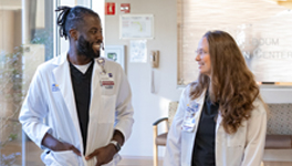 two pharmacists walking and smiling