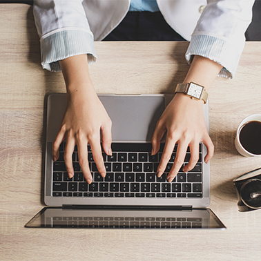 woman working on laptop for application materials